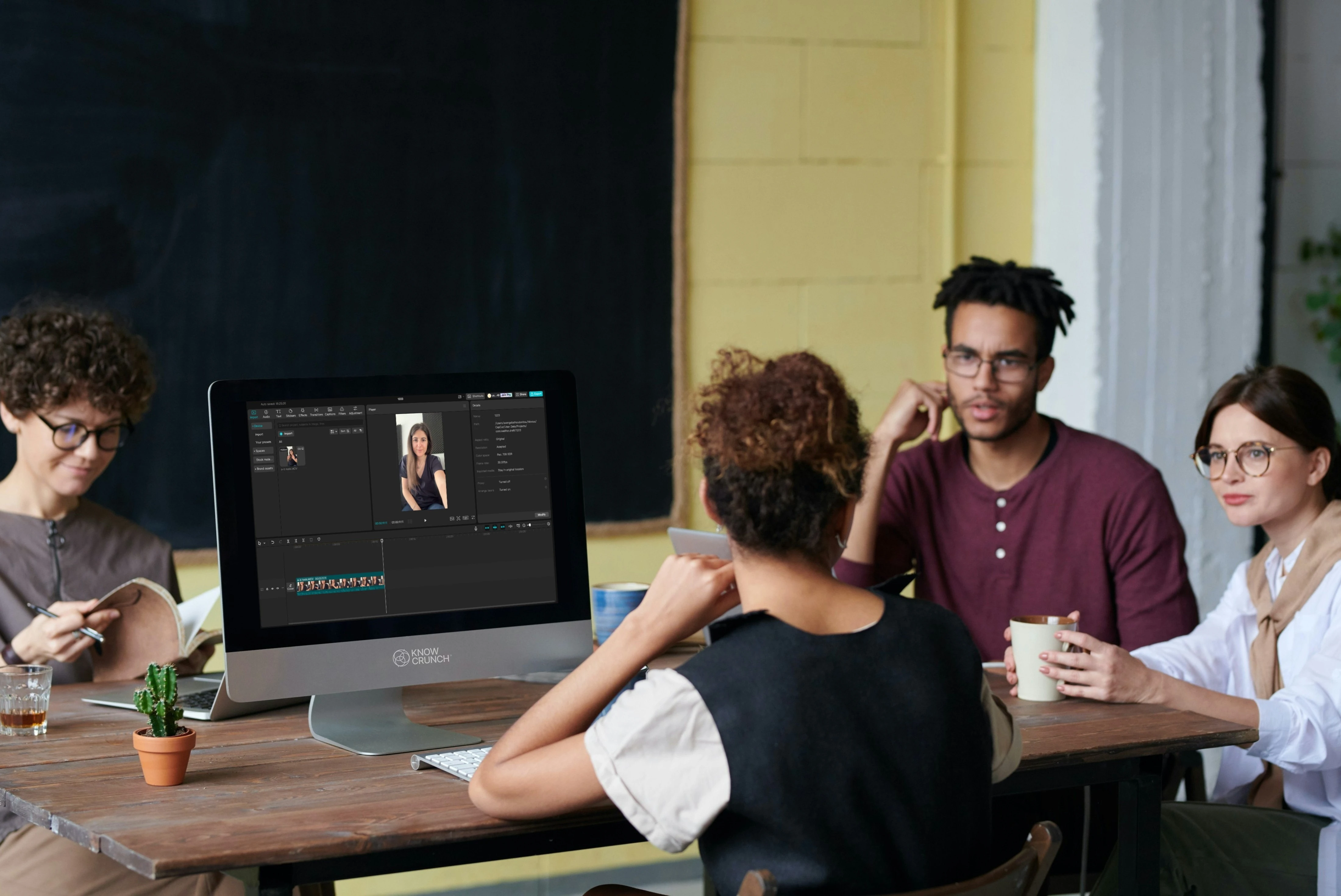 Woman presenting a social media marketing strategy to a team in a modern meeting room.