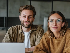 Woman presenting a social media marketing strategy to a team in a modern meeting room.