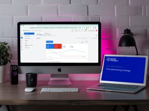 Desktop setup showing Google Ads performance dashboard alongside a Knowcrunch digital advertising strategy presentation.
