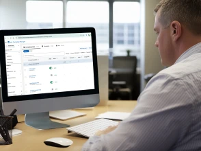 Woman presenting a social media marketing strategy to a team in a modern meeting room.