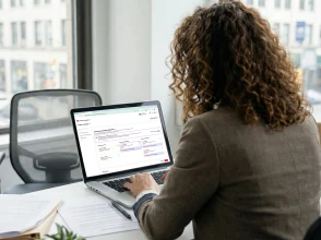 Professional working on a laptop setting up a digital advertising campaign on Pinterest in an office.