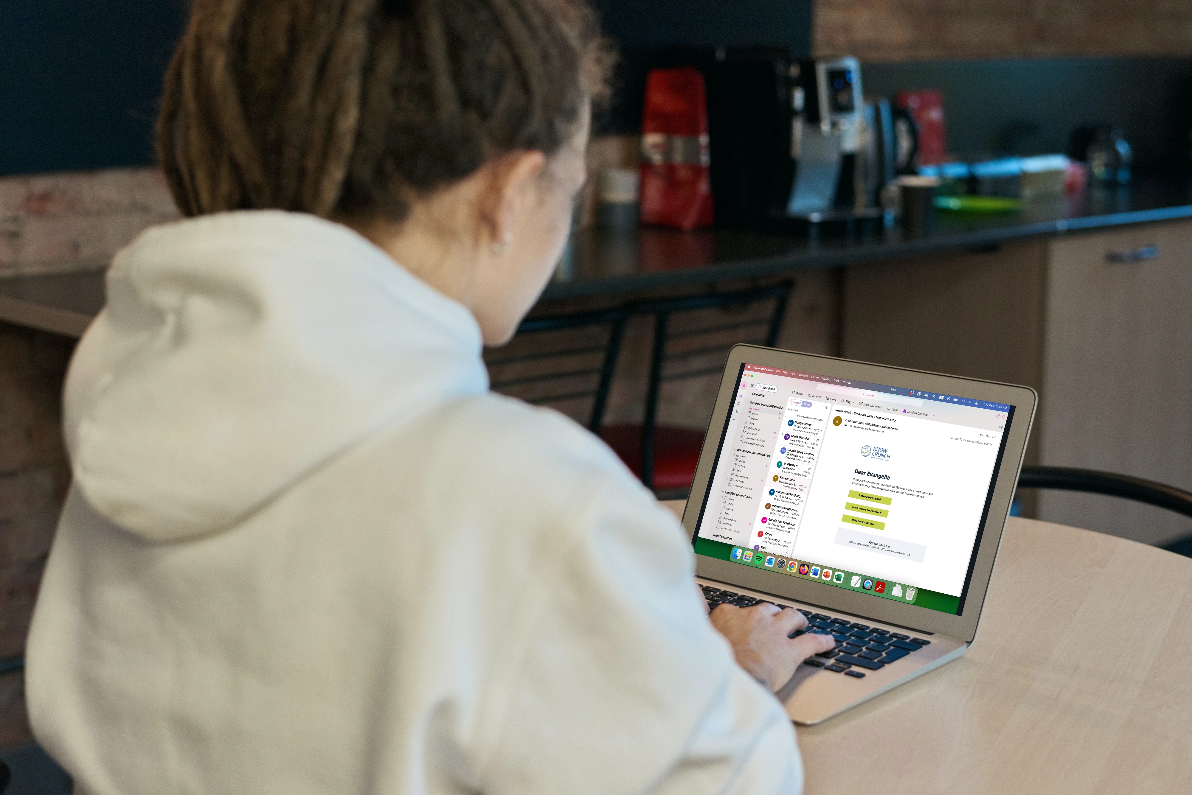 Person working on an email marketing campaign using a laptop in a casual workspace.